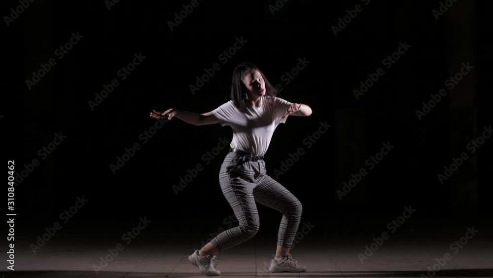 young beautiful girl dancing vogue in the studio on a black background, isolated young beautiful girl dancing vogue in the studio on a black background, isolated