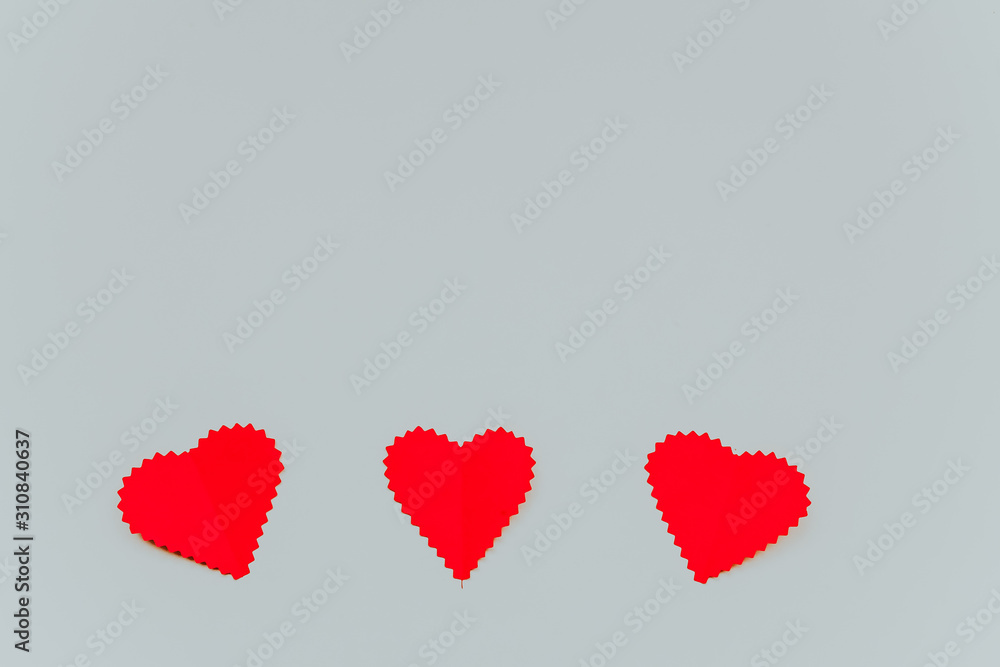 Three red paper hears on the light grey background. Saint Valentine s Day concept. Three red paper hears on the light grey background. Saint Valentine s Day concept.