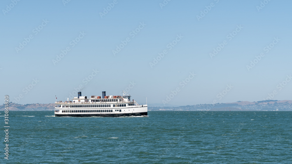 Tourist boat touring Alcatraz in the San Francisco Bay, California, USA.