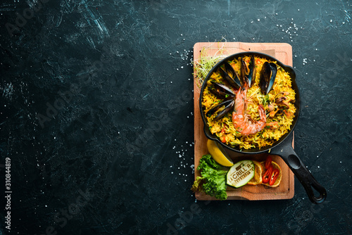 Seafood rice. Paella with mussels and shrimp. Top view. Free space for your text.