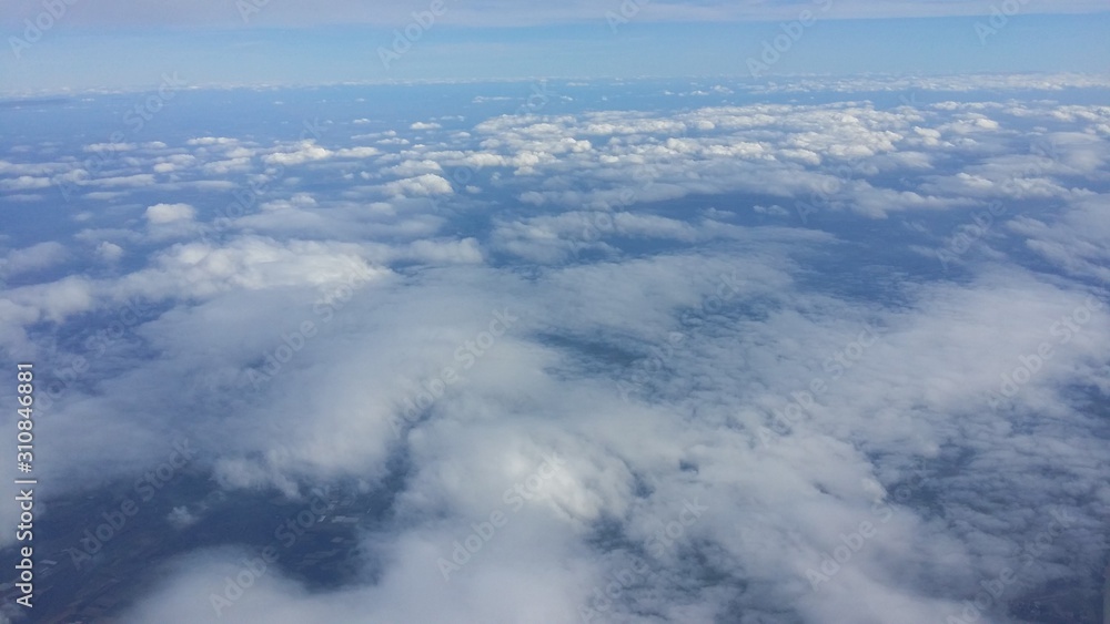 Sky above the clouds looked upon from the window of an airplane Sky above the clouds looked upon from the window of an airplane