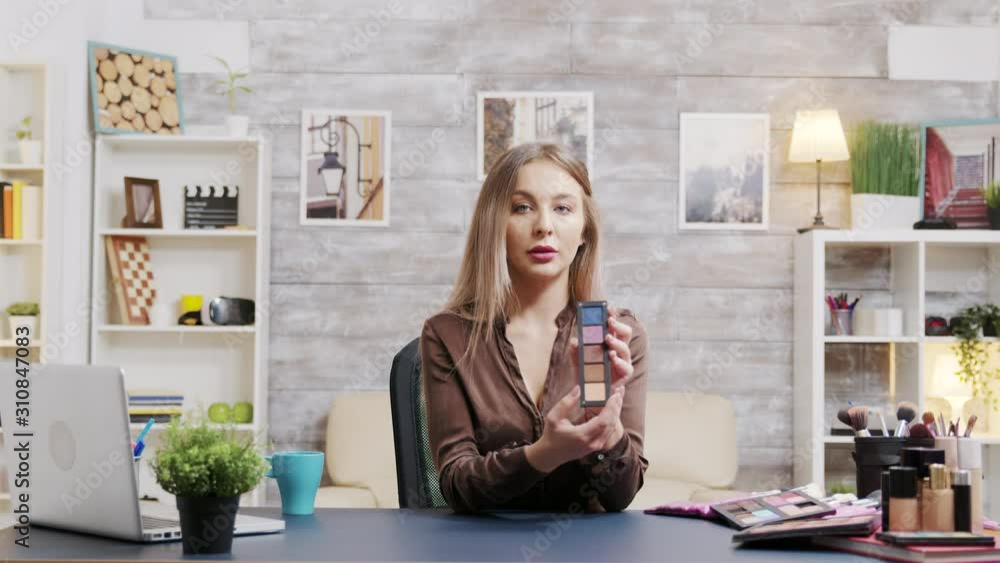 Beautiful fashion vlogger presenting different skin cosmetics Beautiful fashion vlogger presenting different skin cosmetics