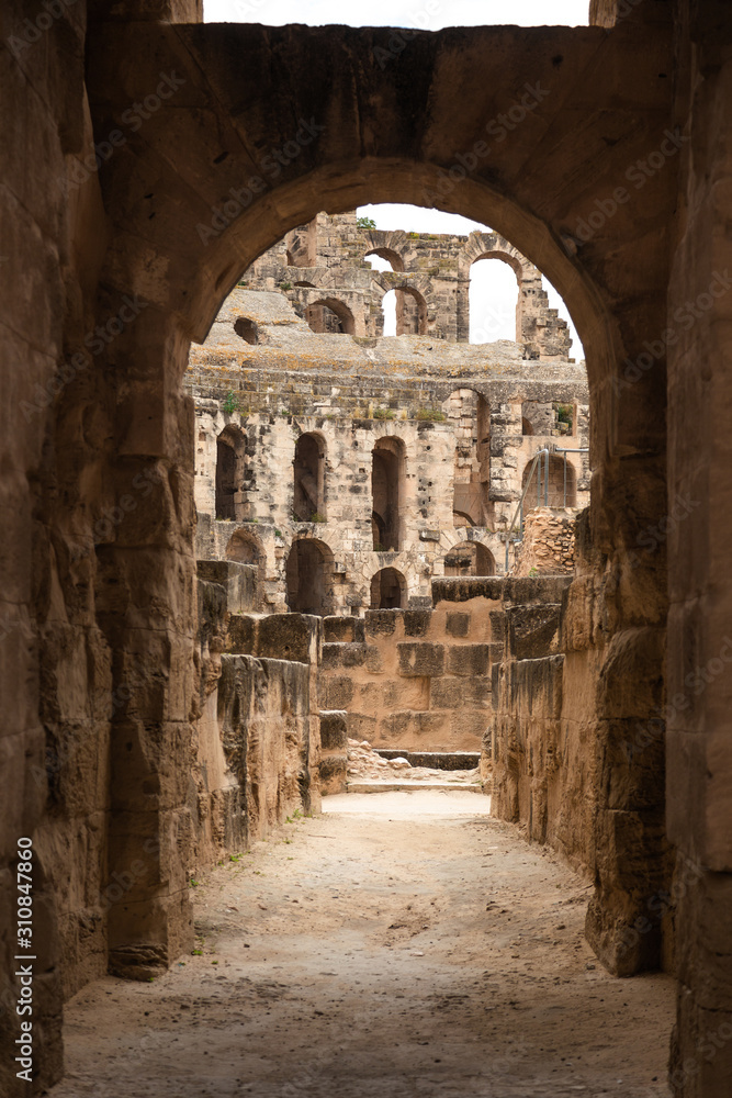 Old antique amazing well conserved huge Amphitheatre of El Jem in Tunisia. Vertical color photography.