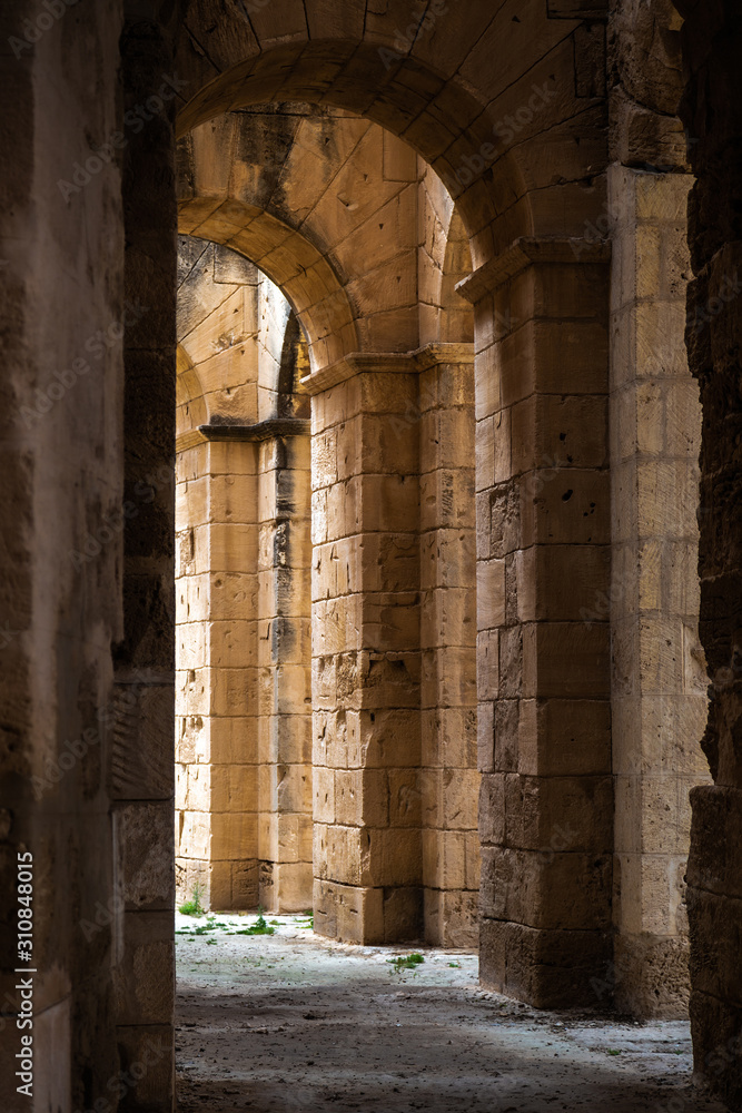 Ancient walls of old architecture. Tunisia. El Djem. Vertical color photography. Ancient walls of old architecture. Tunisia. El Djem. Vertical color photography.