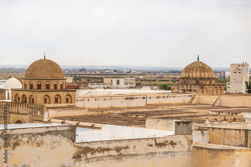 Aerial view of cityscape of Kairouan. Tops of beautiful ancient Great Mosque in Tunisia, North Africa. Horizontal color photography.