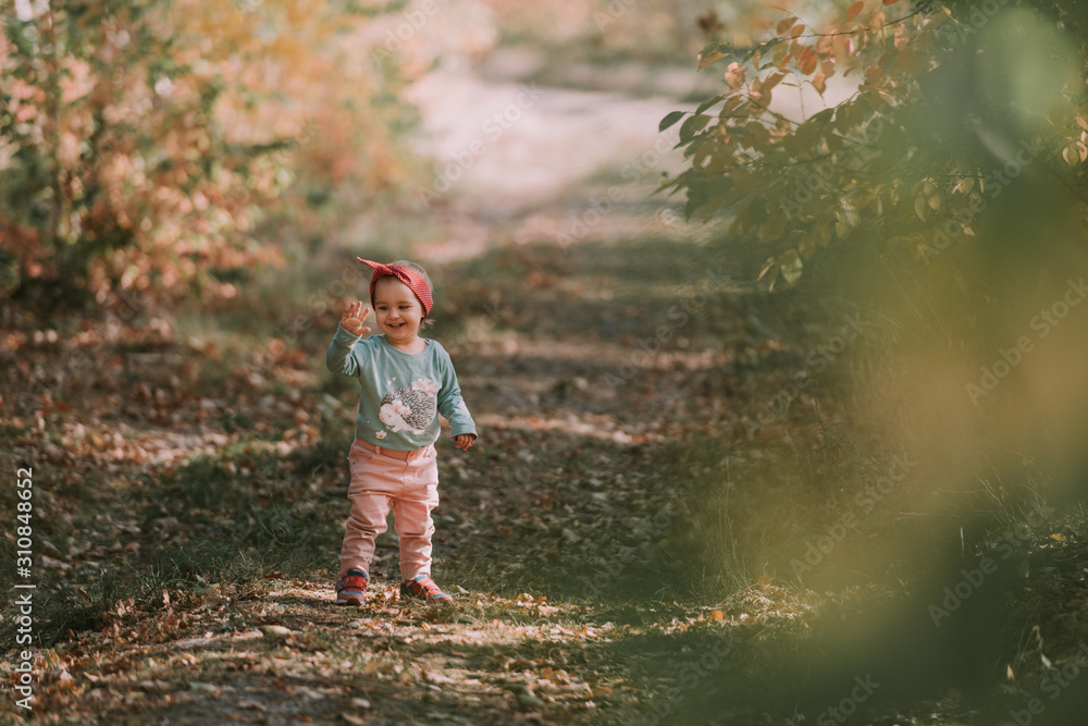 Adorable girl having fun on beautiful autumn day. authentic childhood image. Adorable girl having fun on beautiful autumn day. authentic childhood image.