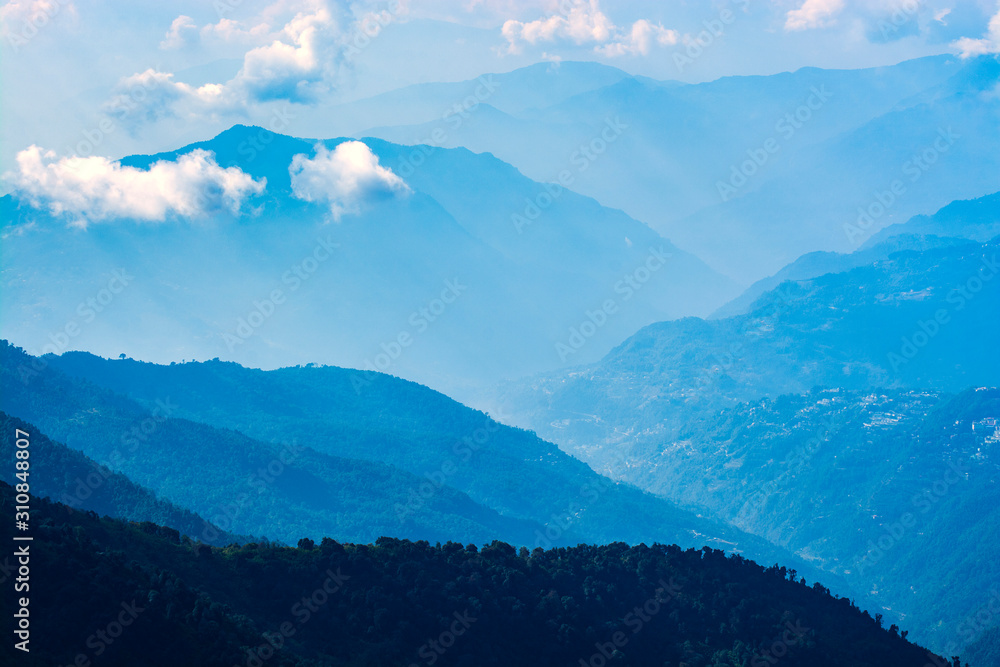 Fototapeta Mountains in blue tone with clouds, travel in India, Himalayas Range, landscape image