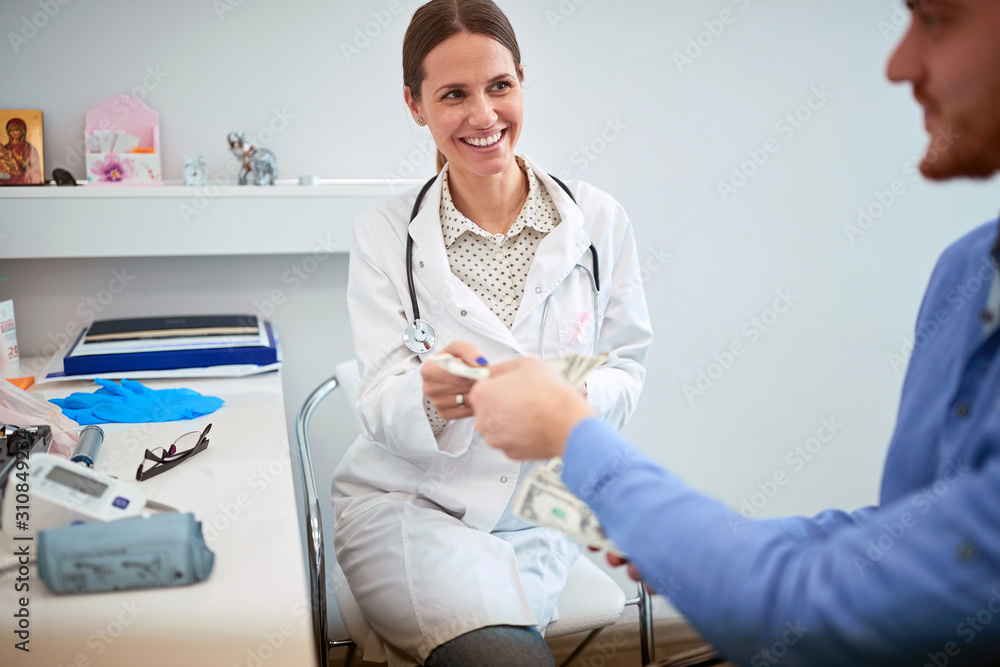 Fototapeta premium Patient paying to doctor for examine