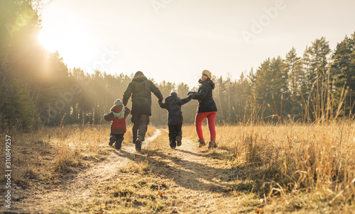 Fototapeta Naklejka Na Ścianę i Meble -  family running on country road