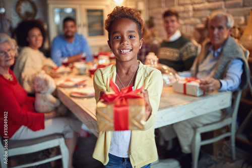 afro American girl holding a Christmas present
