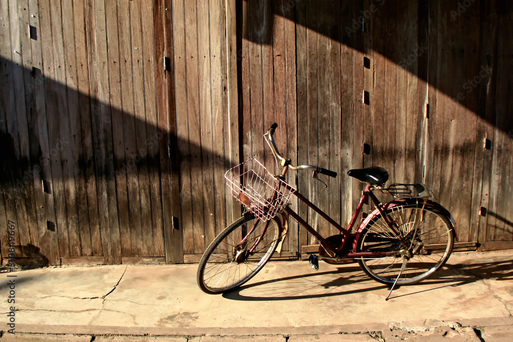 bicycle in front of old wooden wall background bicycle in front of old wooden wall background