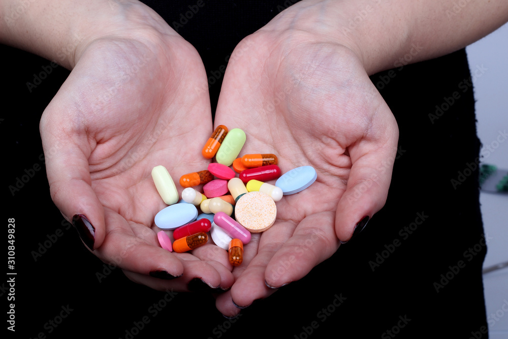 with hands cuffed and medicine pills on black background with hands cuffed and medicine pills on black background
