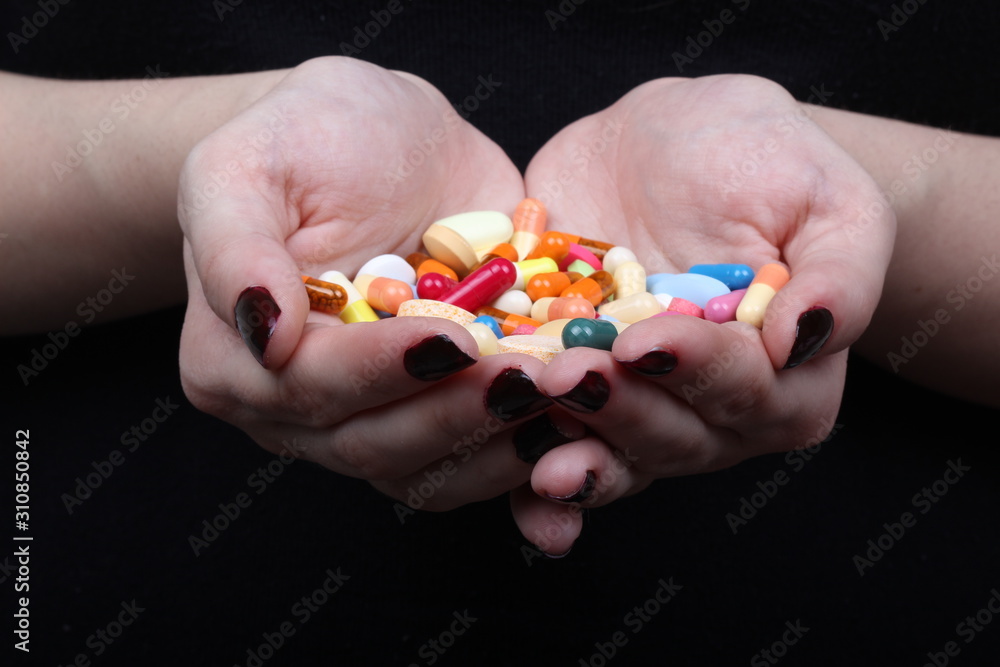 with hands cuffed and medicine pills on black background with hands cuffed and medicine pills on black background