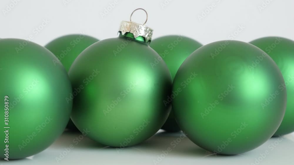 Shiny matte color green baubles topped with cap and hook 4K video Shiny matte color green baubles topped with cap and hook 4K video