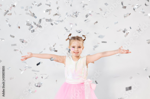 Party, holidays, birthday, new year and celebration concept - Cute child throwing confetti. © satura_