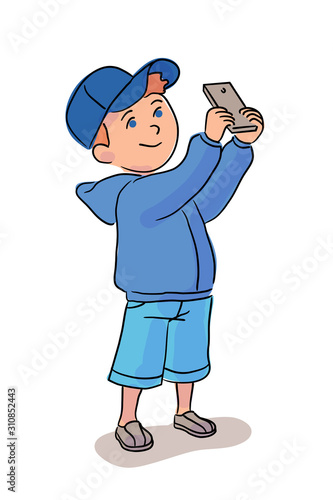 Little boy taking photo on mobile phone on white