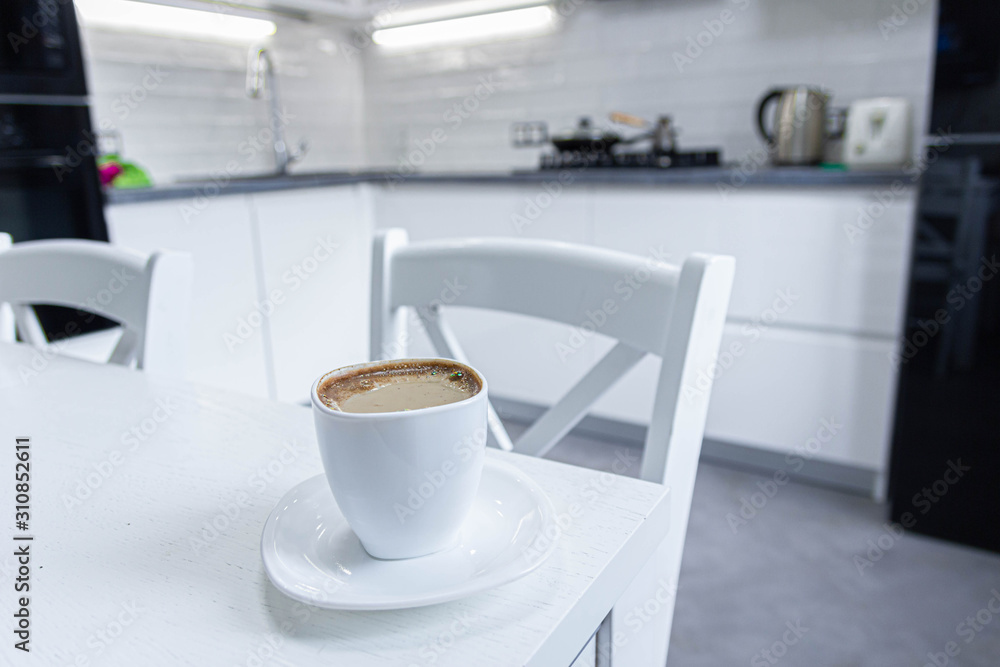 morning coffee with milk on a background of white kitchen interior. morning coffee with milk on a background of white kitchen interior.