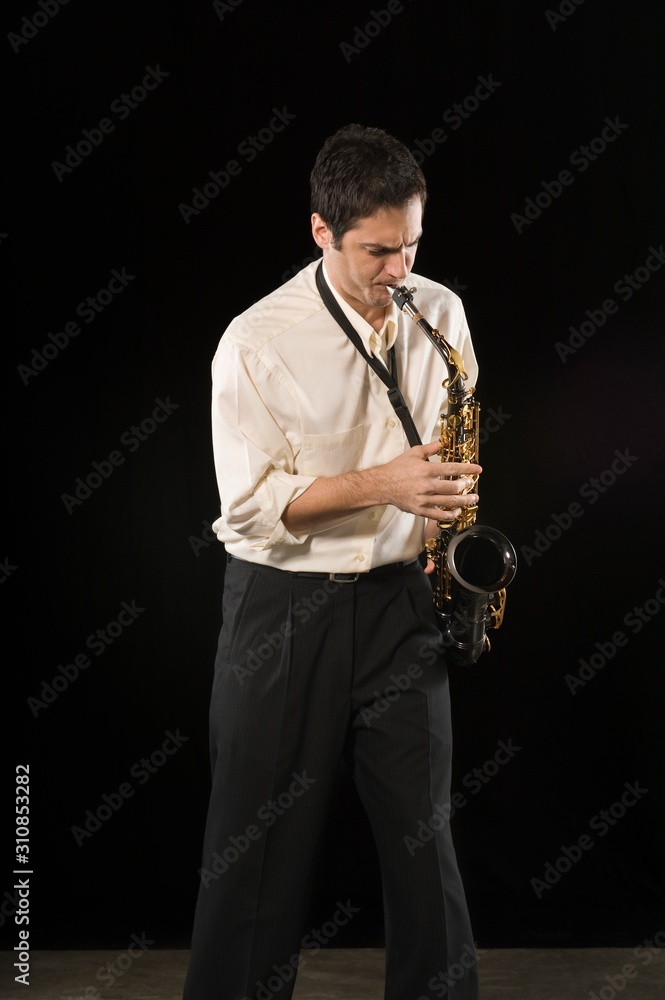 Naklejka premium Caucasian Businessman Blowing Saxophone