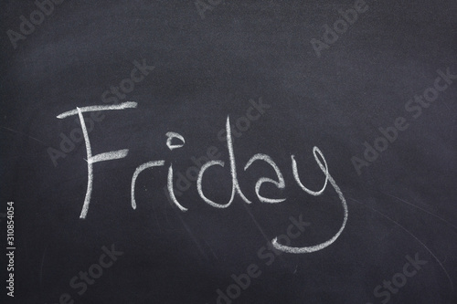 Day of the week written on a blackboard with white chalk, friday