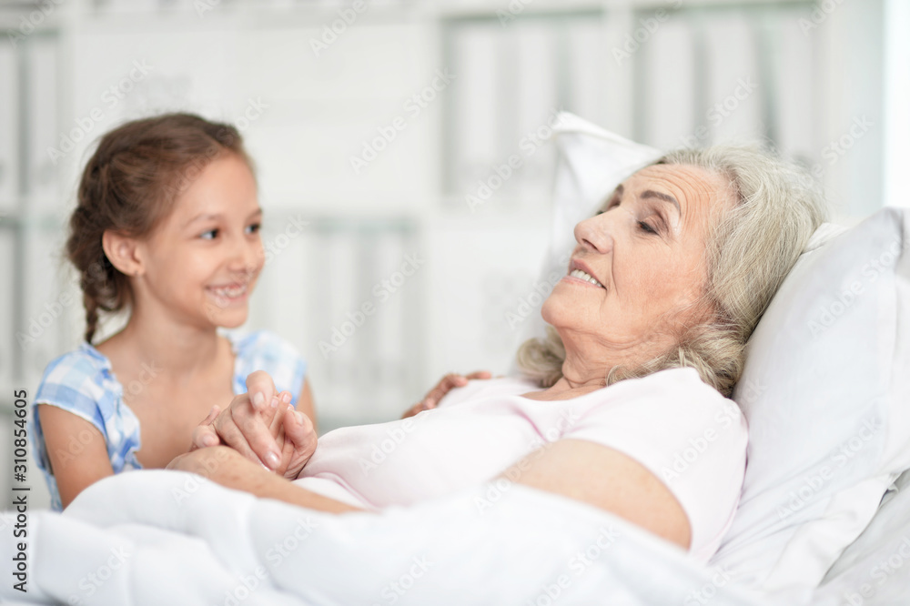 Portrait of granddaughter with grandmother sitting at home Portrait of granddaughter with grandmother sitting at home