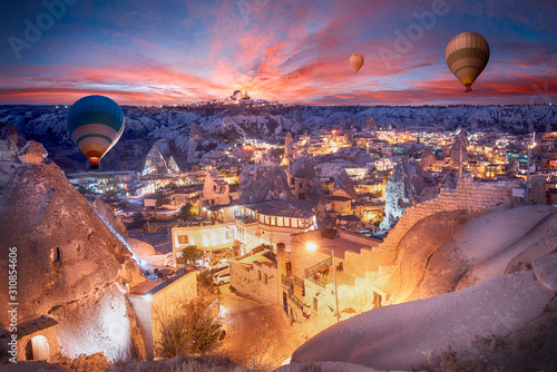 Beautiful scenes in Goreme national park. Colorful hot air balloons flying in the sky on sunset. Incredible rock formations in the valley Cappadocia, Turkey