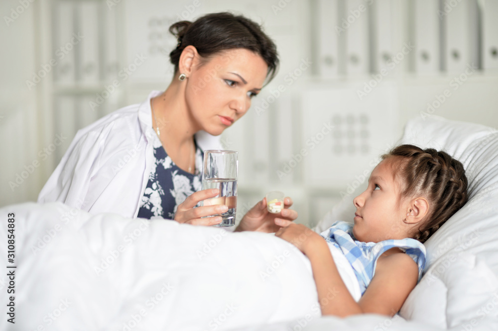 Portrait of sad woman with daughter in hospital ward Portrait of sad woman with daughter in hospital ward