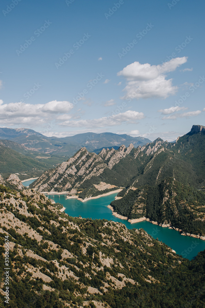 Lake in the mountains with blue water and big mountains on a sunny day in summer 