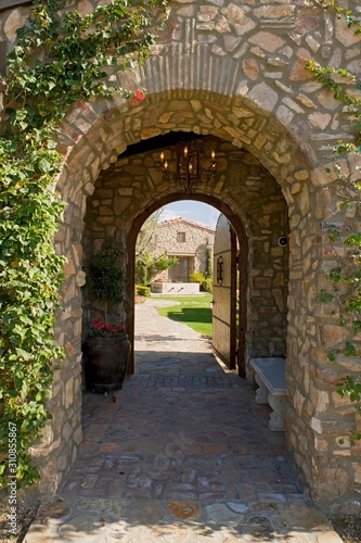 Fototapeta Naklejka Na Ścianę i Meble -  Arched Walkway With Open Door