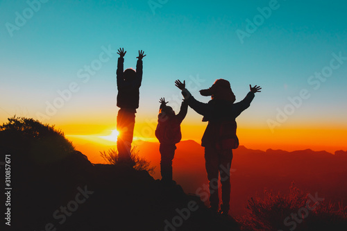 happy father with kids travel in sunset mountains, family hiking in nature
