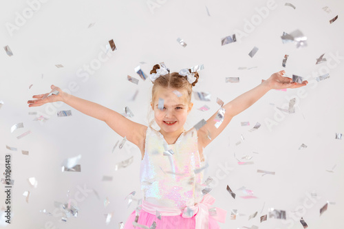 Party, holidays, birthday, new year and celebration concept - Cute child throwing confetti.
