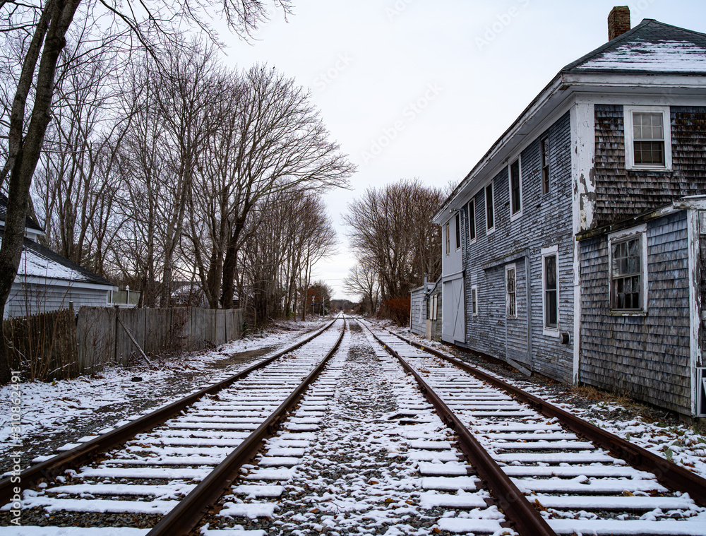 Fototapeta premium Railroad Tracks and A Broken Down Building In Winter