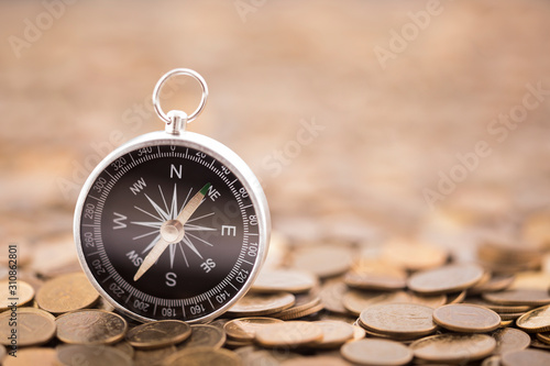 Financial concept with coins and compass