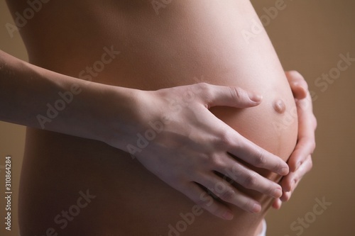 Pregnant Young Woman Holding Tummy