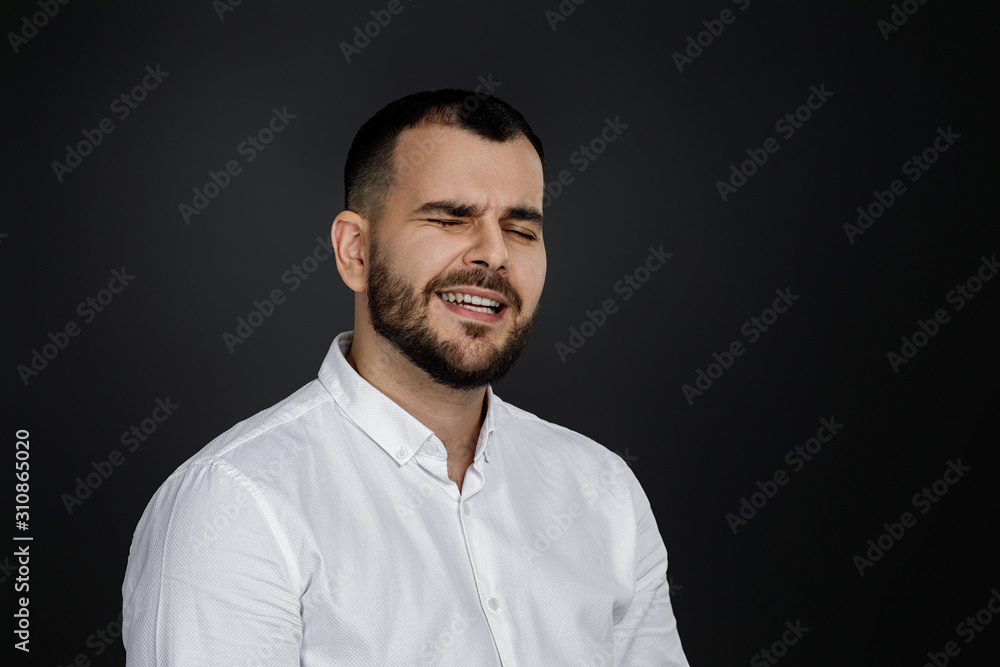 Close-up portrait of happy handsome bearded man laughing on black background Close-up portrait of happy handsome bearded man laughing on black background