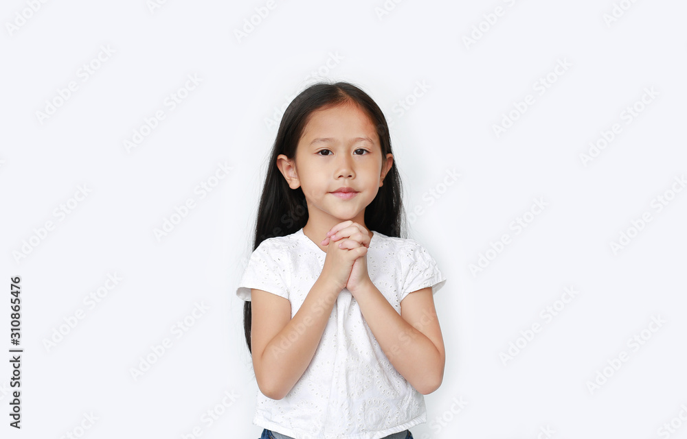 Beautiful little asian child girl praying isolated over white background. Spirituality and religion concept. Beautiful little asian child girl praying isolated over white background. Spirituality and religion concept.