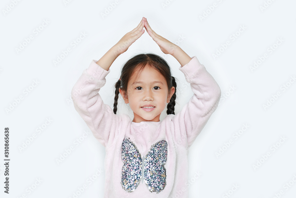 Adorable little girl holding hands over head like a roof house isolated on white background. Adorable little girl holding hands over head like a roof house isolated on white background.