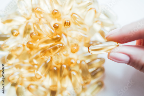 capsule tablet of Omega-3. fish fat oil capsules in spoon on a white background