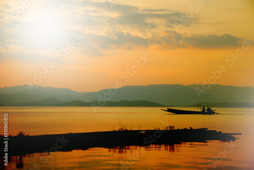 silhouette boat on lake