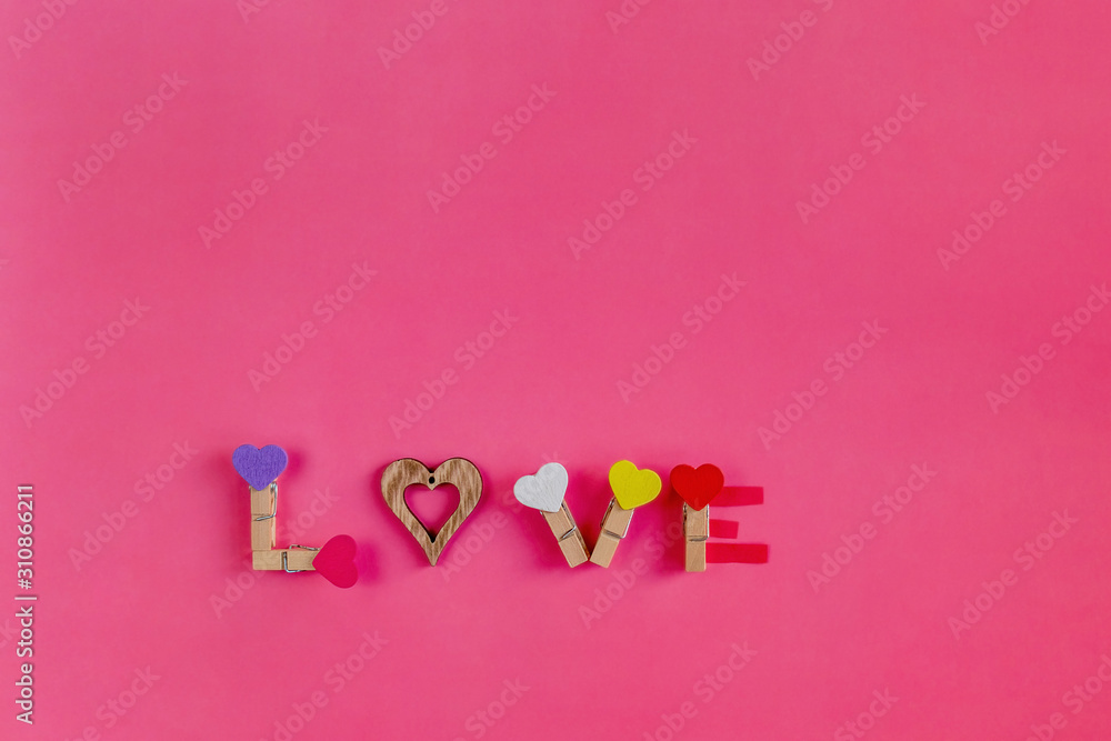 Composition for Valentine's day from multicolor hearts on a pink background. Flat lay, copy space, top view, minimal, February 14th.