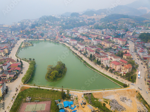 Aerial view of Sapa cityscape with Sapa lake an iconic emerald green lake in the downtown of Sapa the capital city in Lao Cai province in north-west of Vietnam.