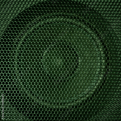 A close up macro photo of a speaker lit with a vibrant green flash gel