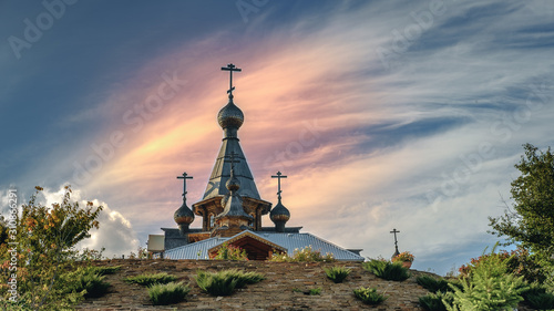 Orthodox wooden Orthodox Church, dome with cross and blue sky. Russia.