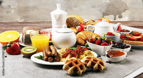 Breakfast served with coffee  orange juice  croissants  cereals and fruits. Balanced diet. Continental breakfast with granola and fruits