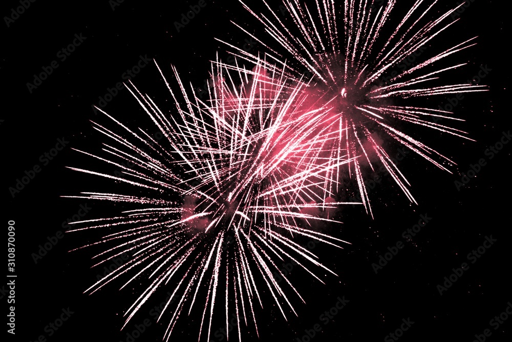 Luxury fireworks event sky show with red big bang stars. Premium entertainment magic star firework at e.g. New Years Eve or Independence Day party celebration. Black background copyspace