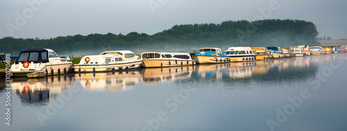 Boats at dawn, Norfolk Broads, England photo