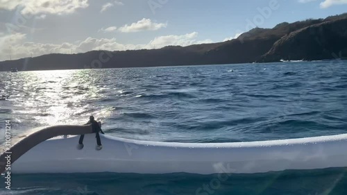 Fernando de Noronha, Pernambuco, Brazil, December 28, 2019: Video of the Havaiana Canoe. They are used for competitions, sports and ecotourism in the background hills and mountains in northeastern Bra photo