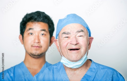 A portrait of Senior adult surgeon and a young Asian doctor