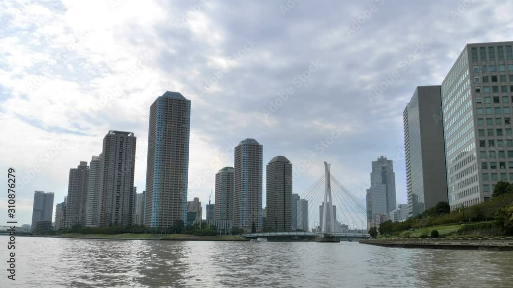 Cruising along the big canal in Tokyo Japan and seeing the high rise building Cruising along the big canal in Tokyo Japan and seeing the high rise building