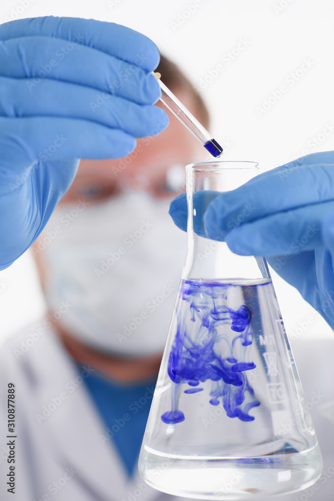Fototapeta premium A male chemist holds test tube of glass