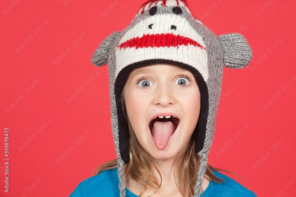 Portrait of girl sticking out tongue against red background Portrait of girl sticking out tongue against red background